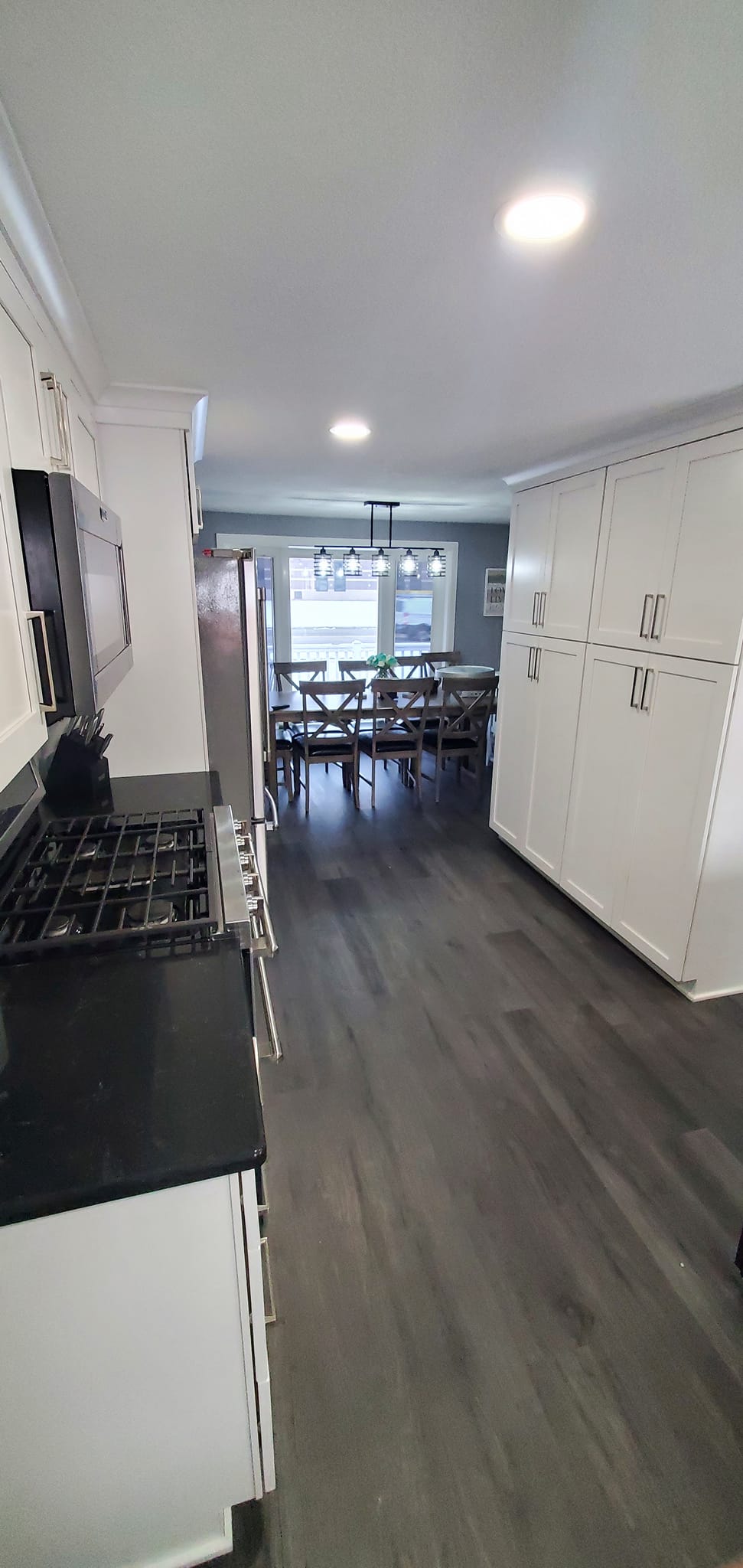 Kitchen remodel, wide angle showing new flooring and cabinetry