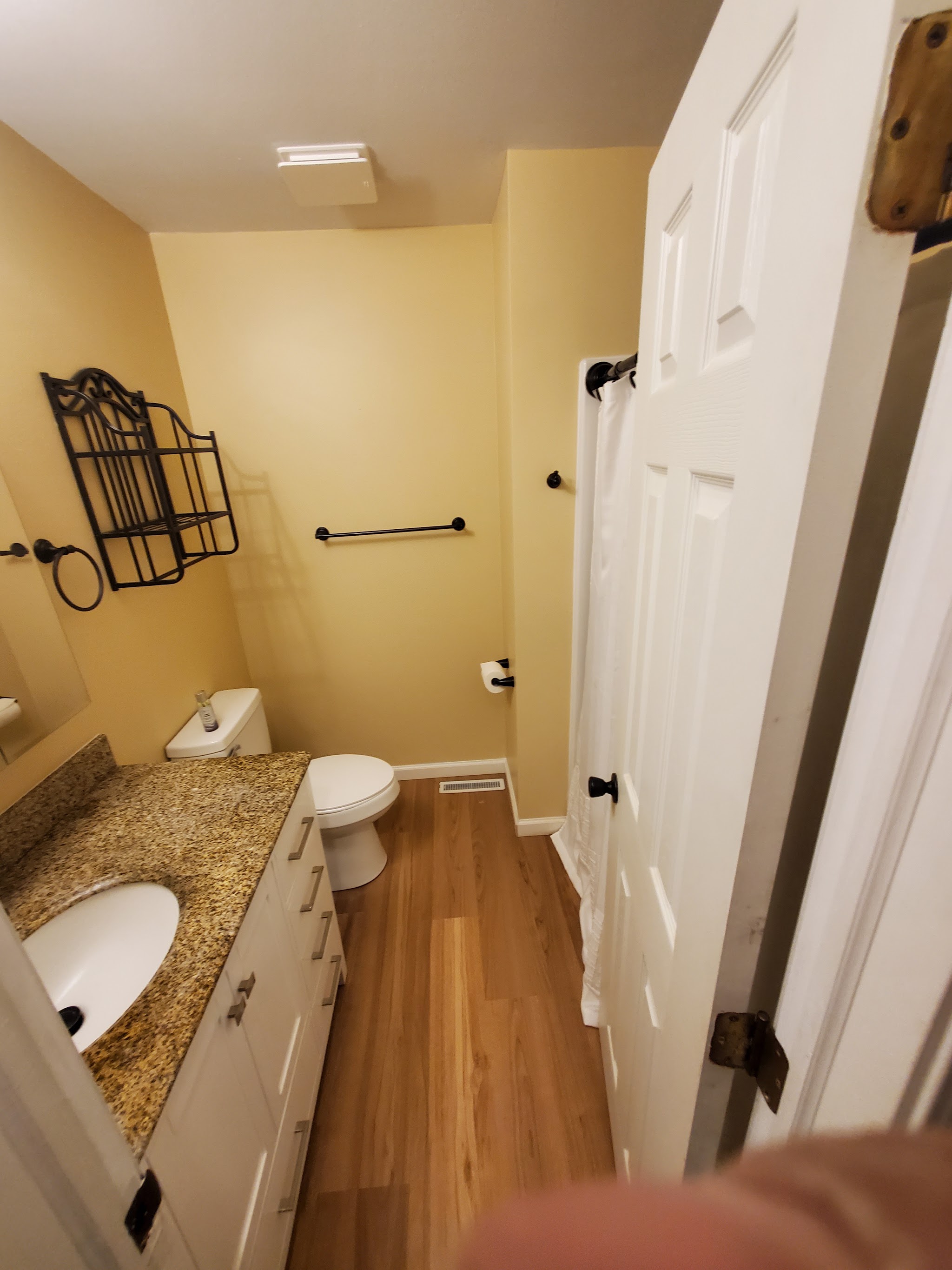 Finished bathroom with granite vanity top